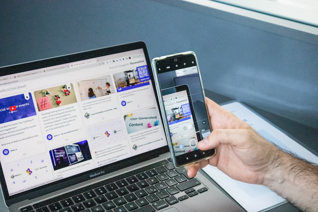 Person scanning a QR code on a laptop with their smartphone